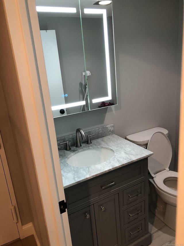 bathroom with vanity and toilet