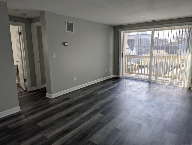 unfurnished room featuring dark hardwood / wood-style floors