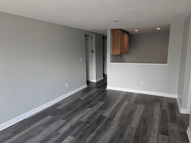 spare room featuring dark hardwood / wood-style flooring