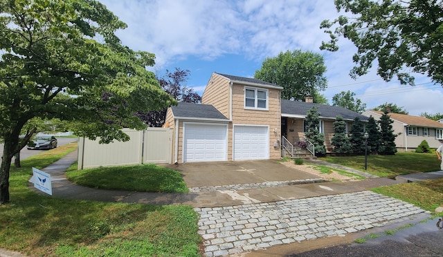 view of front of house featuring a garage and a front lawn