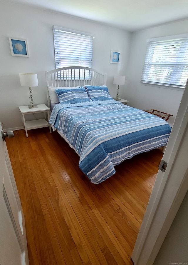 bedroom with hardwood / wood-style flooring