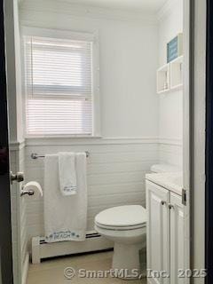 bathroom featuring vanity, a baseboard radiator, and toilet