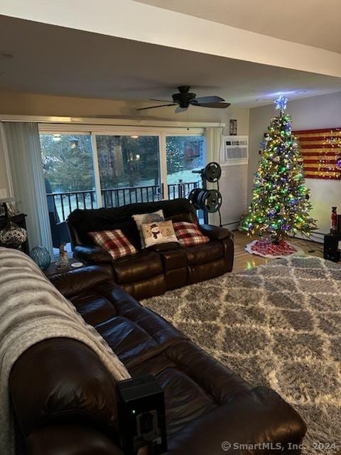 living room featuring a wall mounted air conditioner, ceiling fan, and hardwood / wood-style flooring