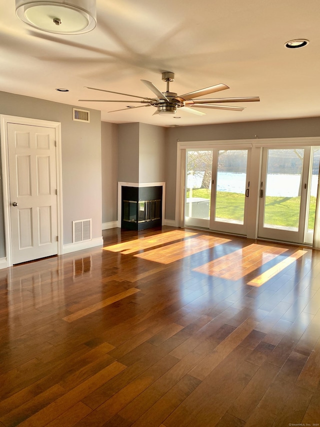 unfurnished living room with ceiling fan and hardwood / wood-style floors