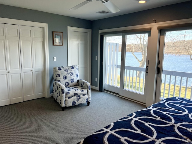 carpeted bedroom with ceiling fan, a water view, and access to outside