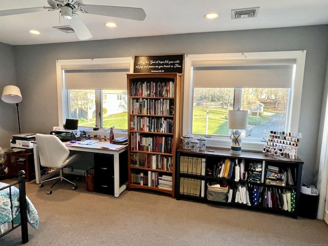 home office with ceiling fan and light carpet