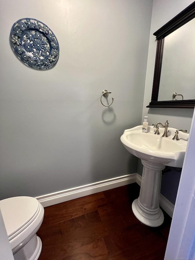 bathroom featuring hardwood / wood-style floors and toilet