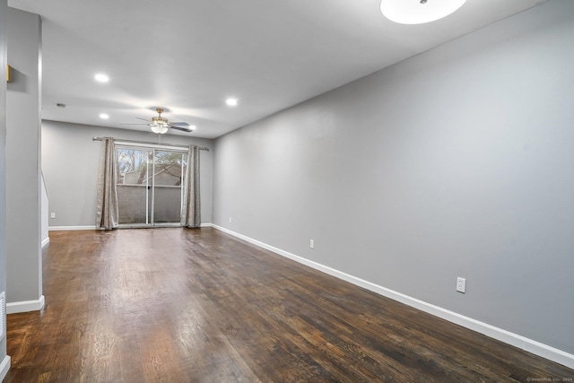 spare room featuring dark hardwood / wood-style floors and ceiling fan