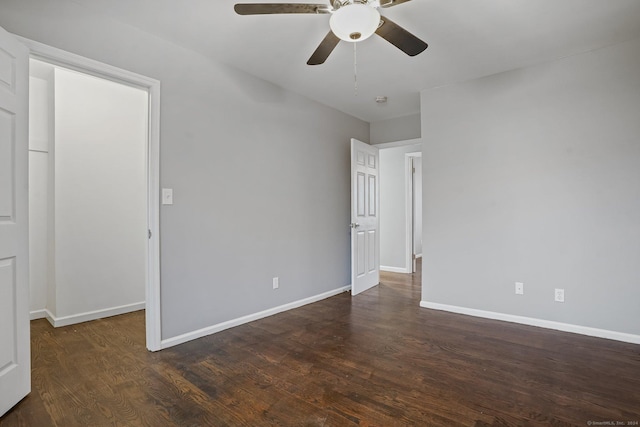 empty room with dark hardwood / wood-style flooring and ceiling fan