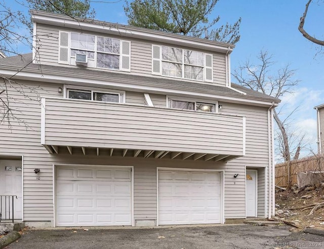 view of front of home featuring a balcony and a garage