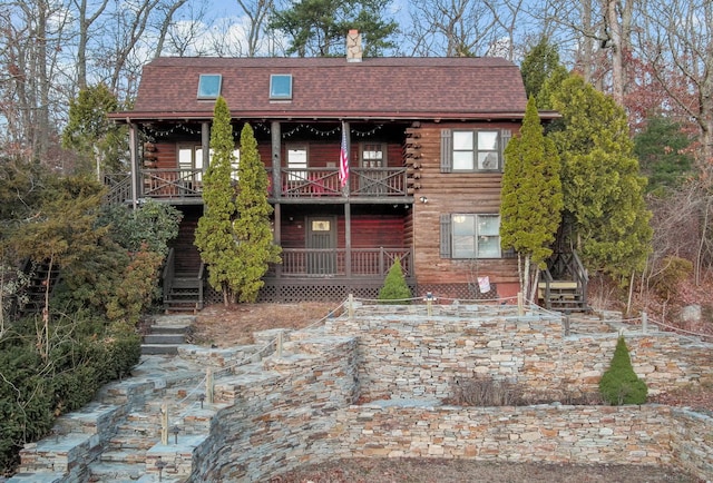 log cabin with a balcony