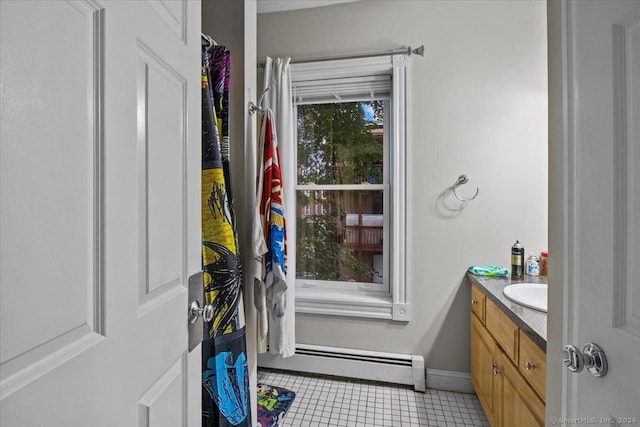 bathroom featuring tile patterned floors, vanity, and baseboard heating