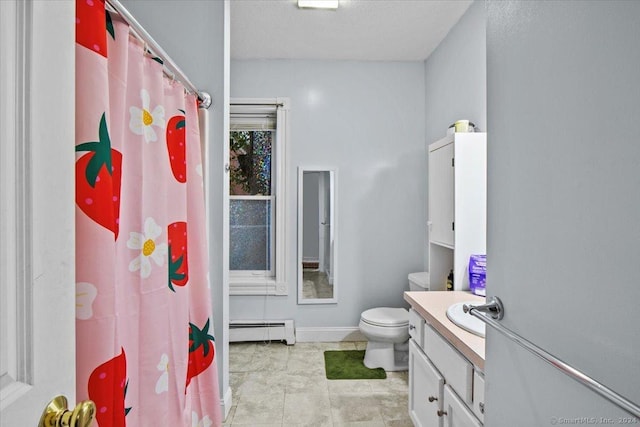 bathroom featuring toilet, vanity, and a baseboard heating unit