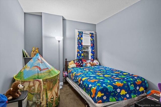 bedroom with carpet floors and a textured ceiling