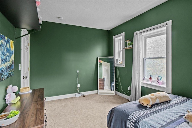 bedroom featuring carpet floors and a textured ceiling