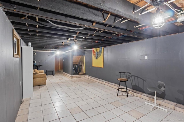 basement featuring light tile patterned floors