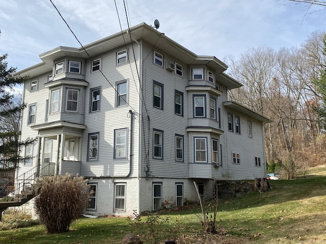 view of side of home with a yard