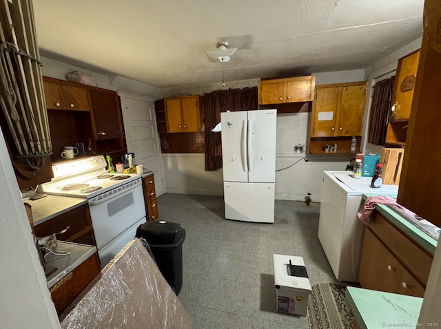 kitchen featuring washer / clothes dryer and white appliances