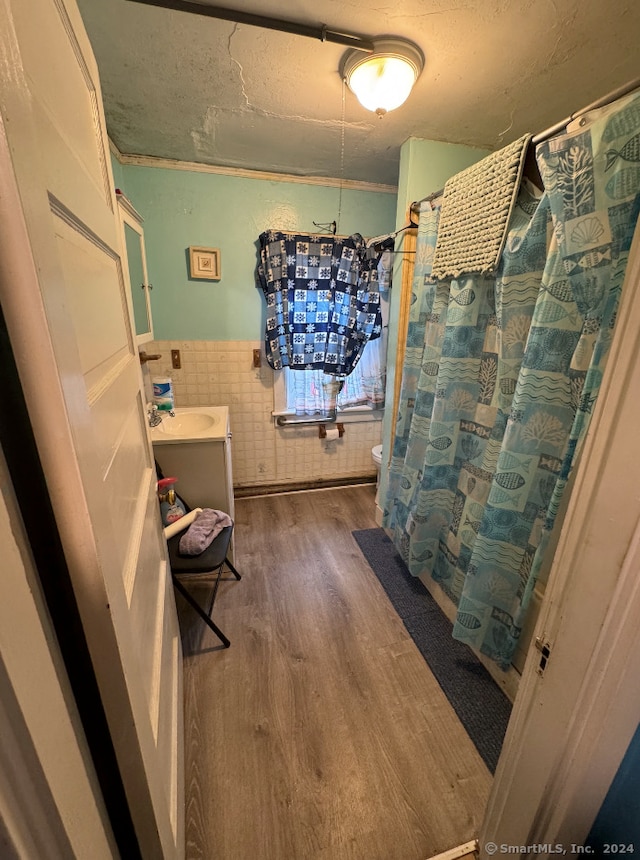 bathroom featuring a shower with curtain, wood-type flooring, and toilet