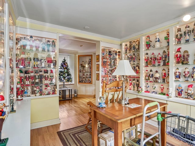 dining area with light hardwood / wood-style flooring and crown molding