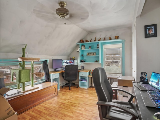 office space featuring lofted ceiling, ceiling fan, and light wood-type flooring