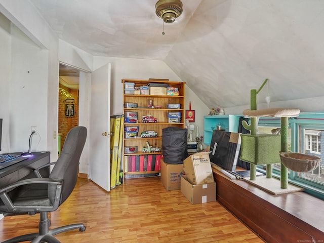 home office featuring light hardwood / wood-style flooring and lofted ceiling