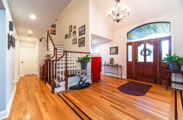 foyer with a notable chandelier and light hardwood / wood-style floors