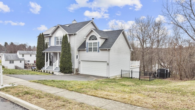 view of property featuring a front yard and a garage