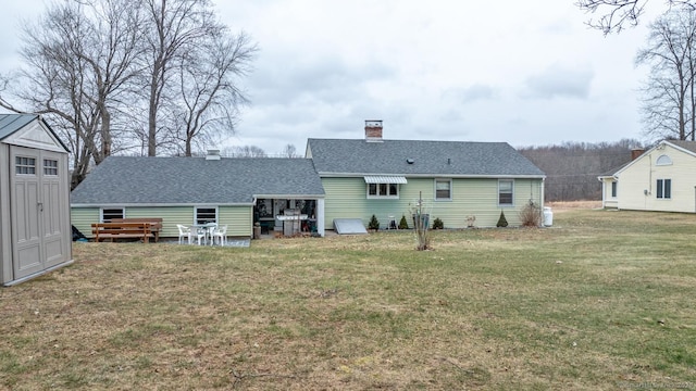 rear view of property with a lawn