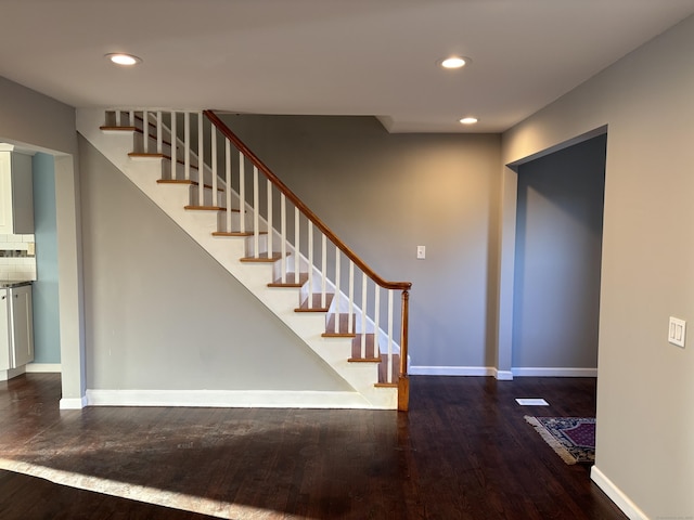 staircase with hardwood / wood-style floors