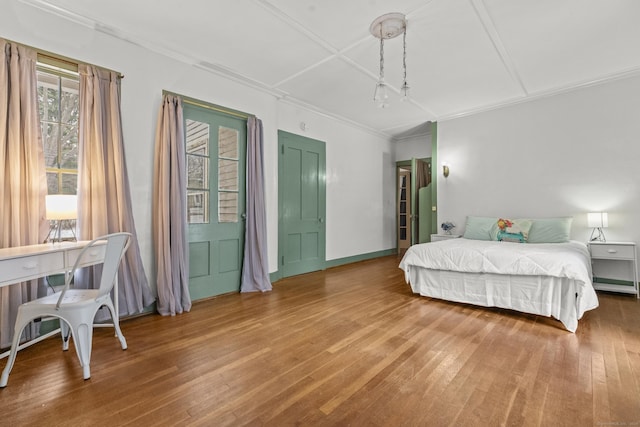 bedroom with hardwood / wood-style floors and crown molding