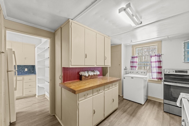 kitchen featuring stainless steel range, cream cabinetry, light hardwood / wood-style floors, and washer / dryer