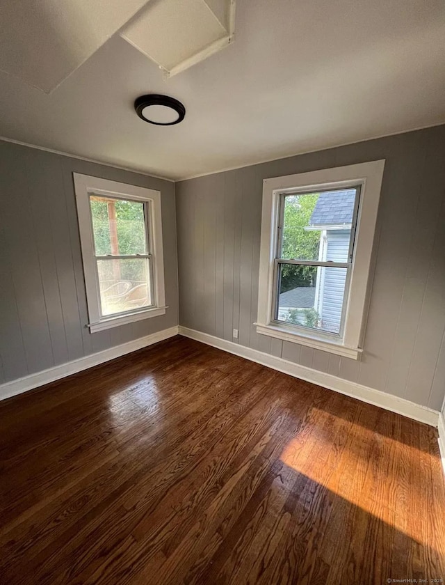 unfurnished room with dark hardwood / wood-style floors