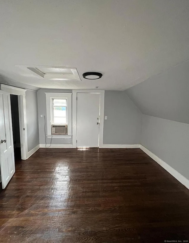 bonus room with dark hardwood / wood-style flooring, cooling unit, and lofted ceiling