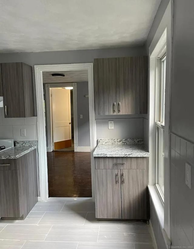 kitchen featuring light stone counters and light wood-type flooring