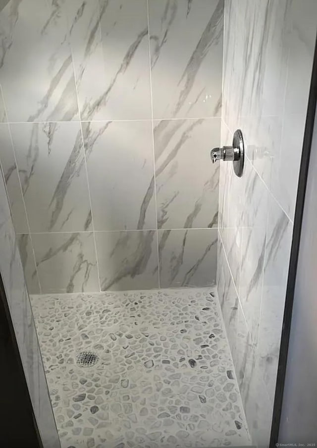 bathroom with tiled shower