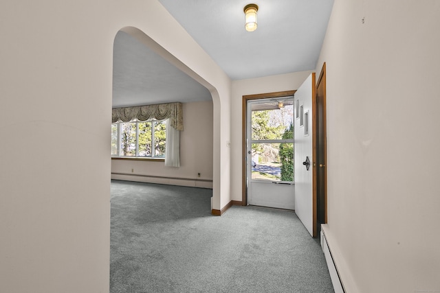 carpeted entryway with baseboard heating and a wealth of natural light