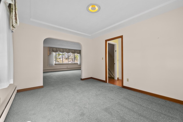 unfurnished room featuring baseboard heating and carpet floors