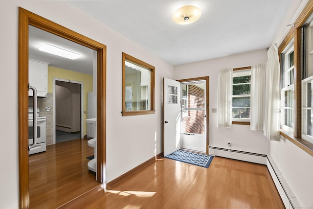 doorway featuring hardwood / wood-style flooring and a baseboard radiator