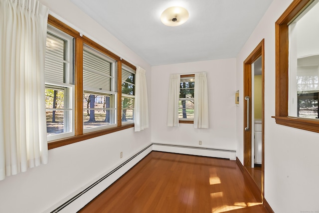 hall with hardwood / wood-style floors and a baseboard radiator