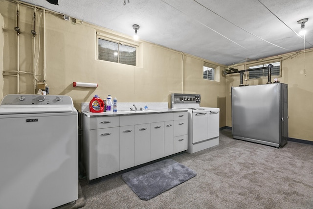 clothes washing area with washer / dryer, a textured ceiling, light colored carpet, and sink