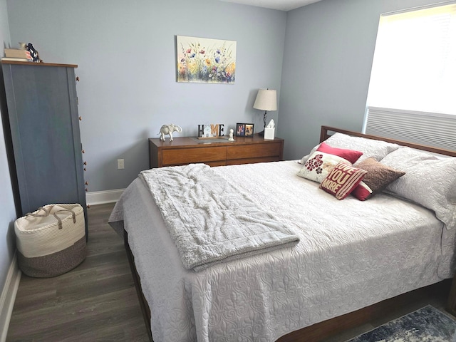 bedroom with dark hardwood / wood-style flooring