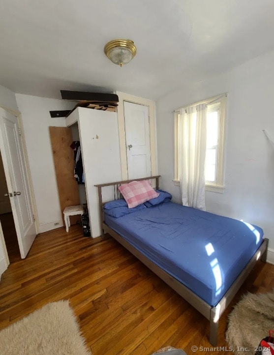 unfurnished bedroom featuring hardwood / wood-style floors