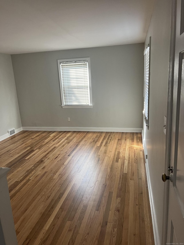 unfurnished room featuring wood-type flooring