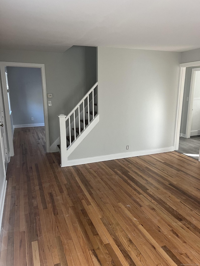 empty room with dark hardwood / wood-style flooring