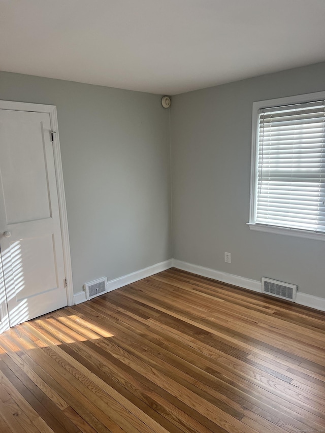 empty room with hardwood / wood-style floors