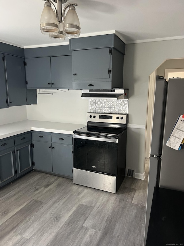 kitchen featuring stainless steel electric range, light wood-type flooring, extractor fan, and fridge