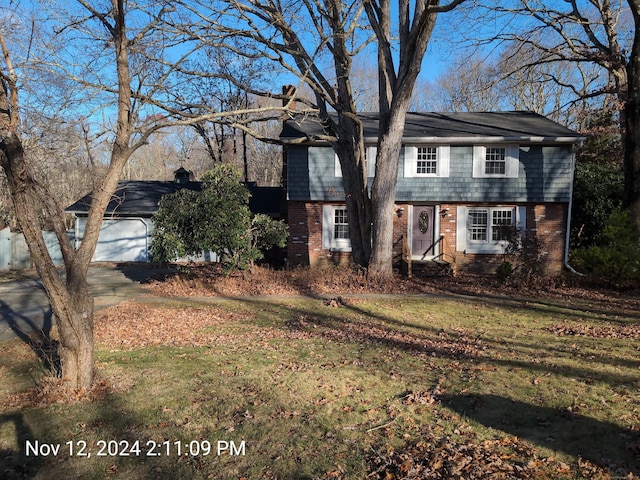 view of front of house with a front yard and a garage