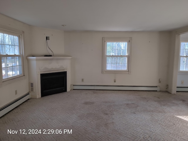 unfurnished living room featuring light carpet and baseboard heating