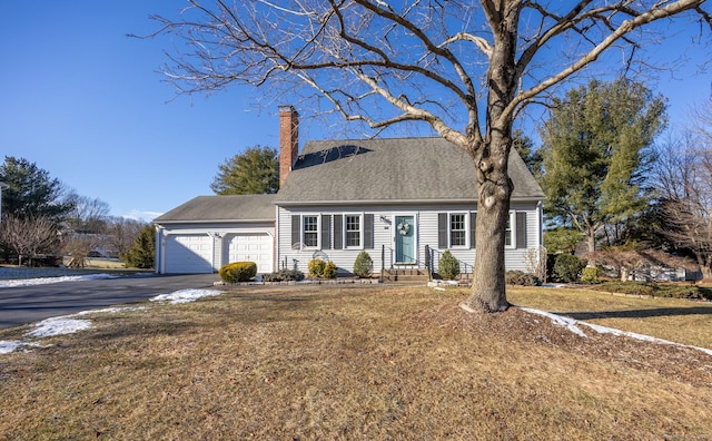 view of front of home with a front yard and a garage